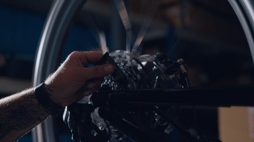 bike mechanic oiling chain